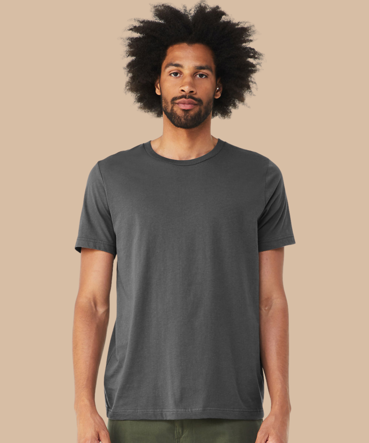 Man wearing a plain dark grey t-shirt against a beige background. Standard stock for Pathfinder Printworks hand printing services. Based in South Wales.