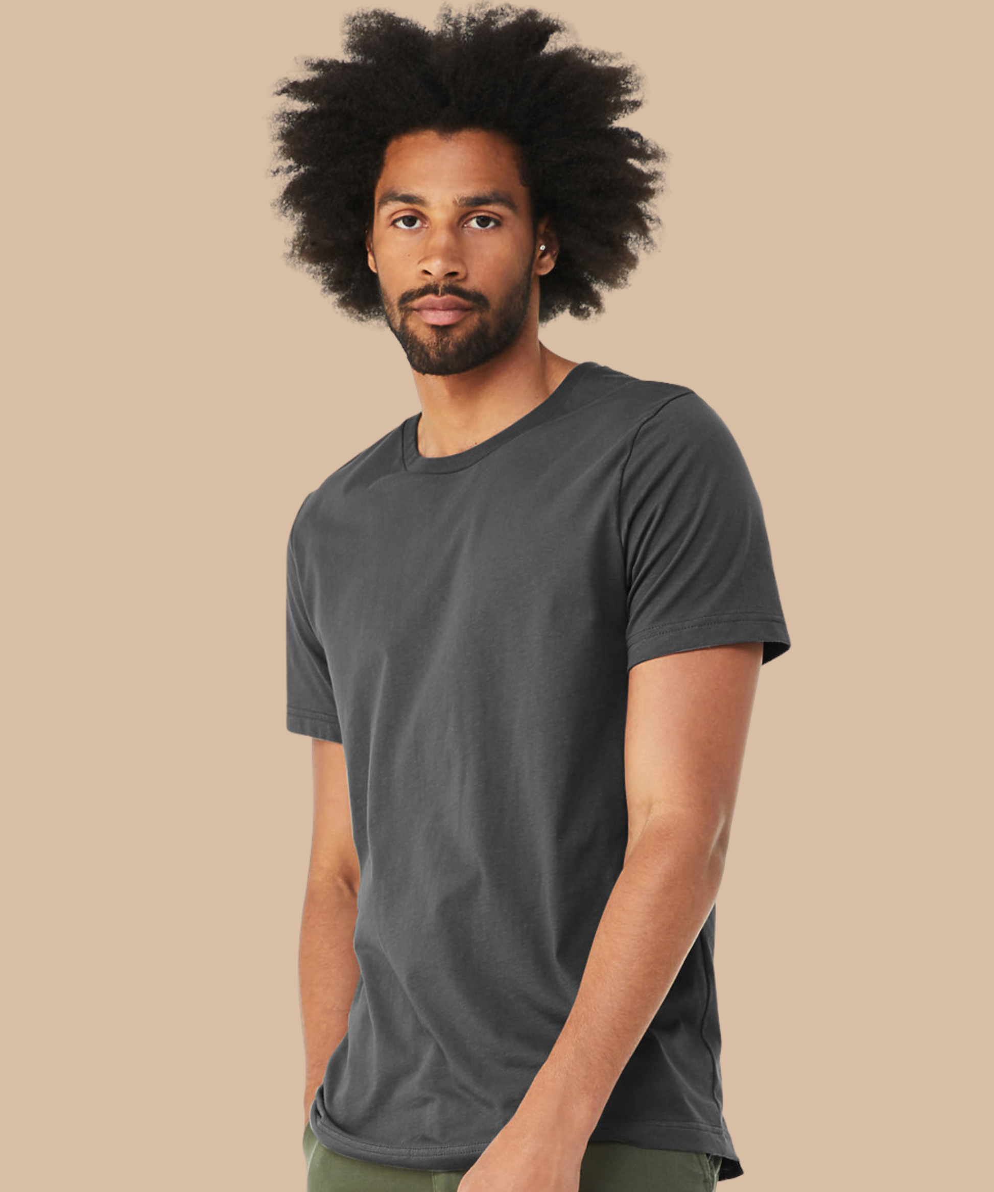 Man wearing a dark grey t-shirt against a beige background. Standard stock for Pathfinder Printworks hand printing services. Based in South Wales.