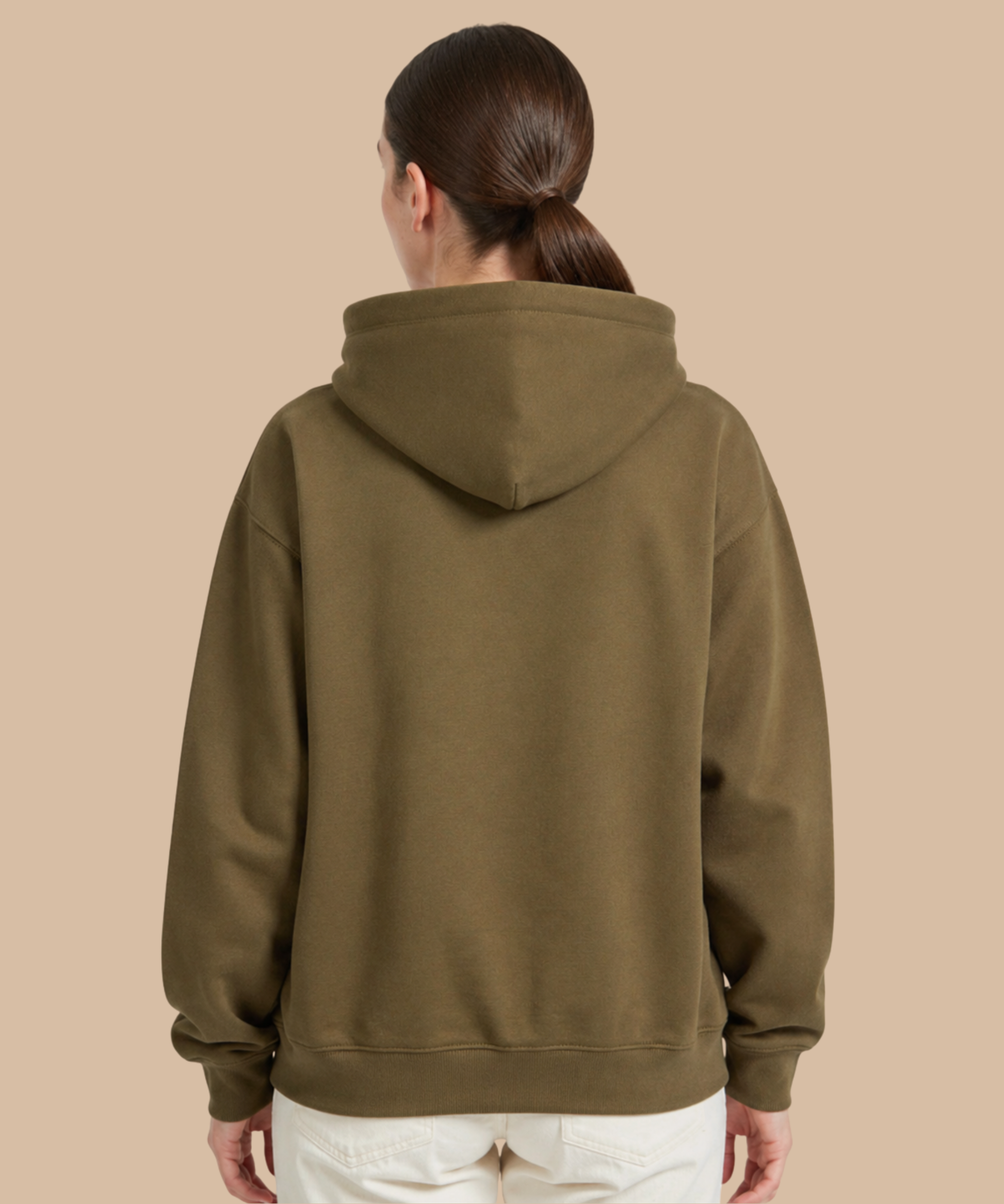 A young woman seen from behind, with slicked-back dark brown hair tied in a low ponytail, wearing a plain olive hoodie. Pathfinder Printworks hand print for clubs, teams and businesses. 