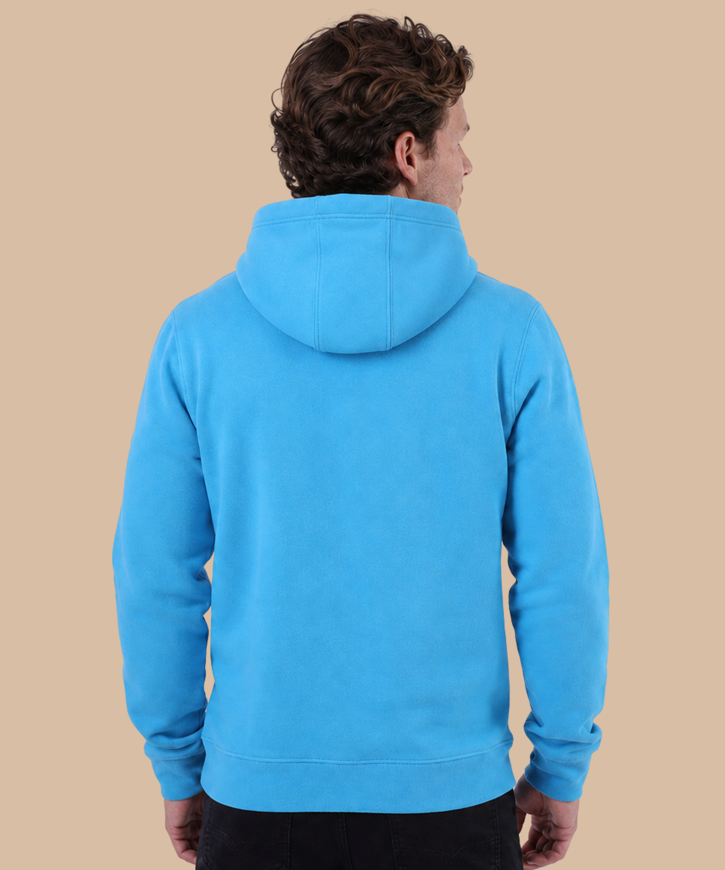 A man viewed from the back wearing a bright blue pullover hoodie against a solid beige background. Pathfinder Printworks hand print apparel for clubs, teams and businesses.