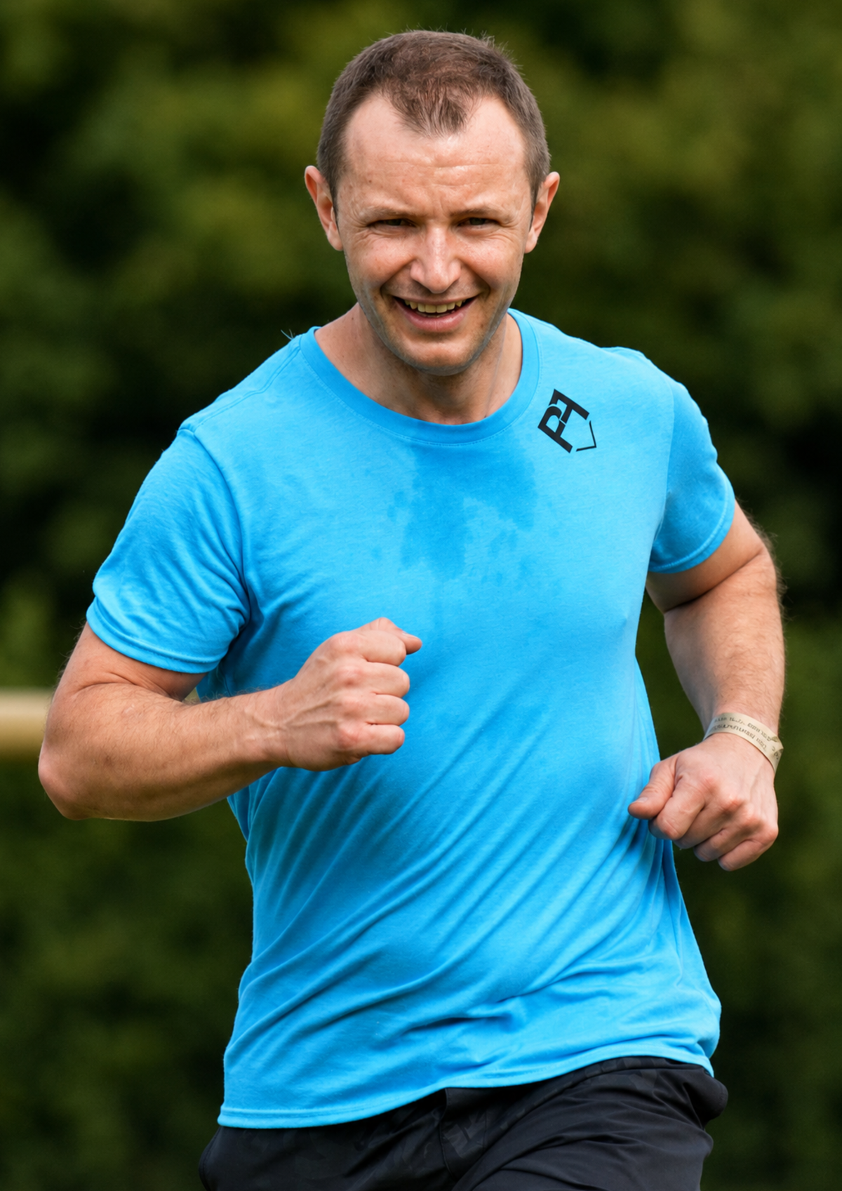 Man running outdoors wearing a blue  team t-shirt. Hand screen printed for Team Pathfinder by Pathfinder Printworks in South Wales.