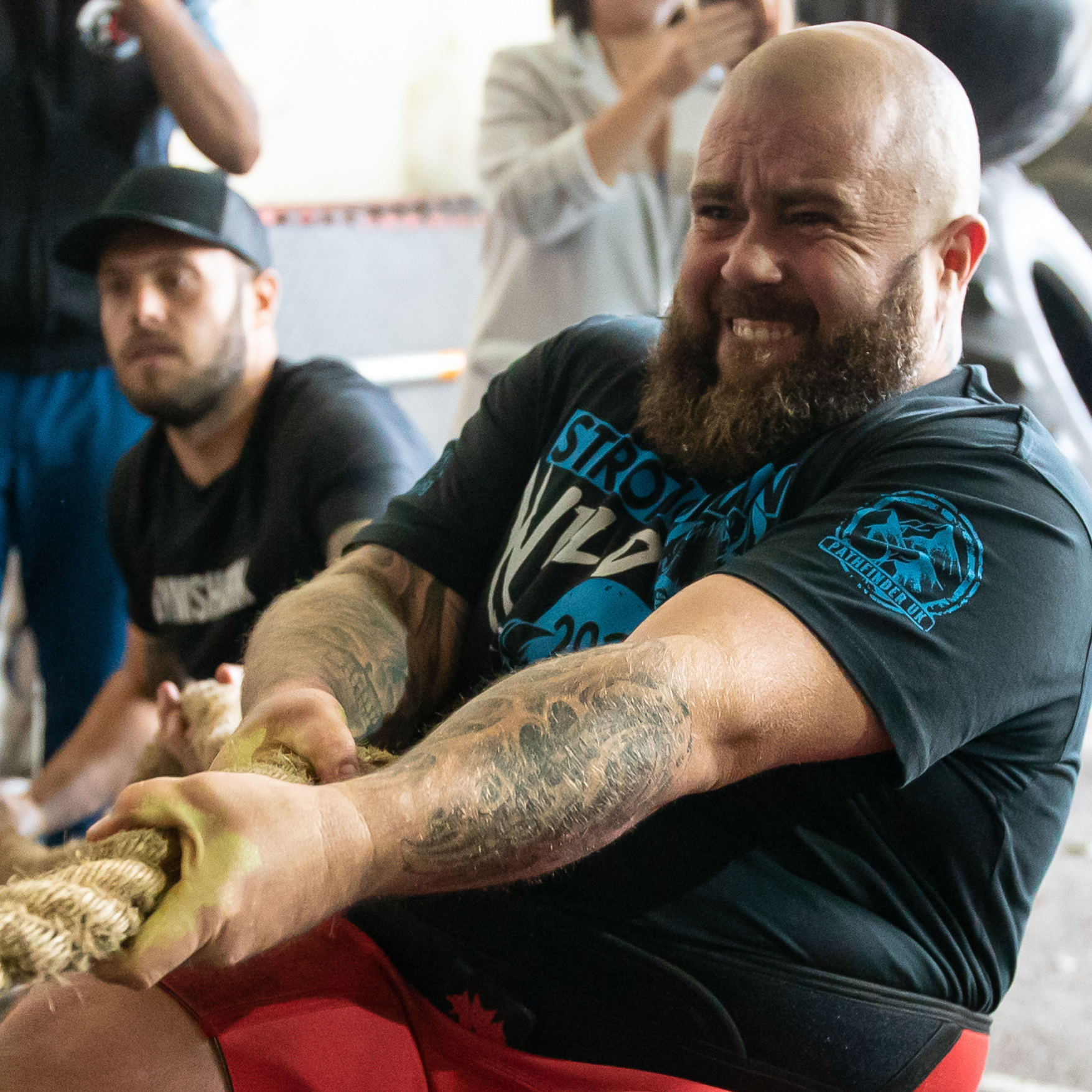 Man wearing a custom printed t-shirt from Pathfinder Printworks while competing in a Strongman event.