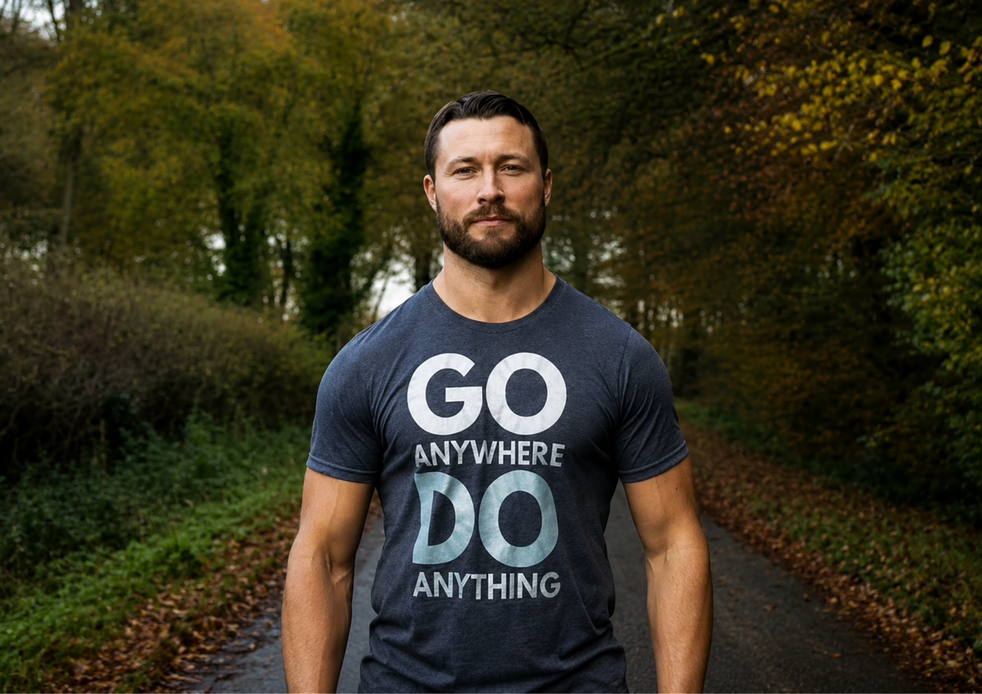 Man wearing a t-shirt with 'GO ANYWHERE DO ANYTHING' text in a forest setting. Hand printed exclusively for Wild Training by Pathfinder Printworks.