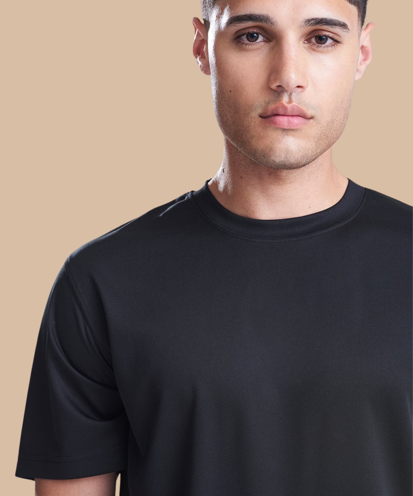 Man wearing a black t-shirt against a beige background. Standard stock for Pathfinder Printworks hand printing services. Based in South Wales.