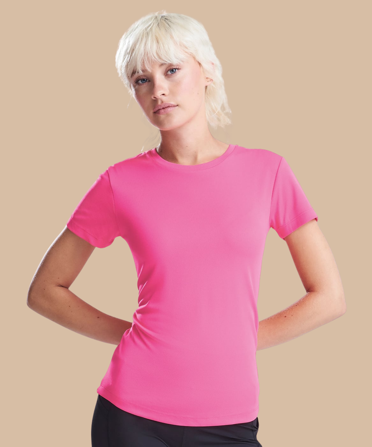 Woman wearing a pink t-shirt against a beige background. Standard stock for Pathfinder Printworks hand printing services. Based in South Wales.