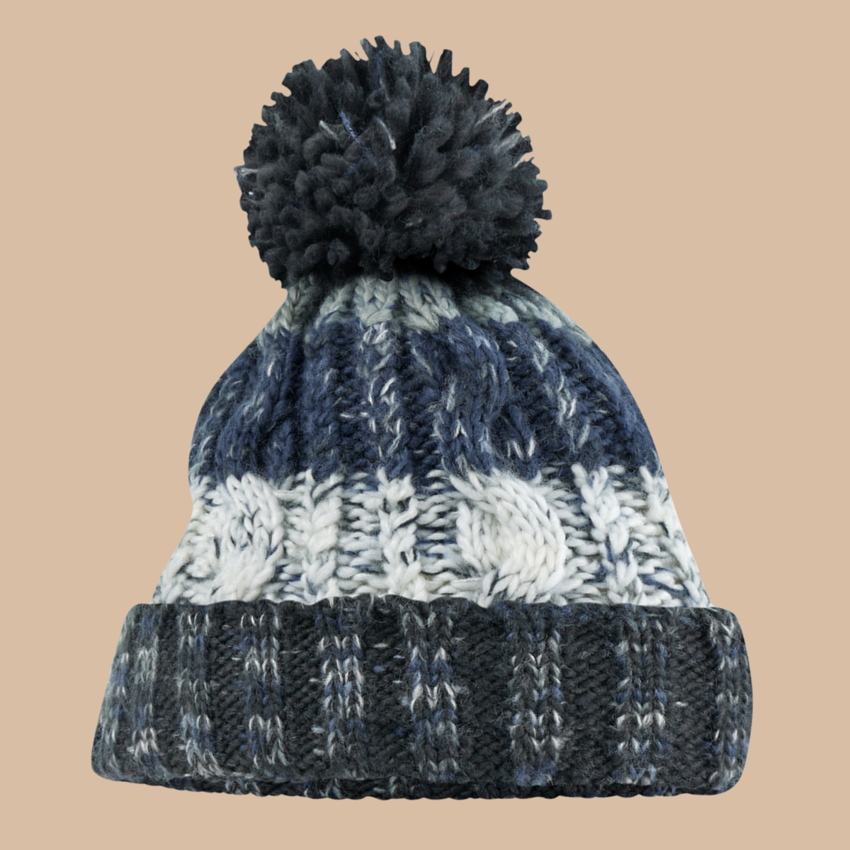 A chunky knit pom-pom beanie hat featuring horizontal stripes of light and dark grey, and white cable knit, with a dark navy ribbed cuff and matching pom-pom, set against a solid beige background. Embroidery services from Pathfinder Printworks, based in South Wales.