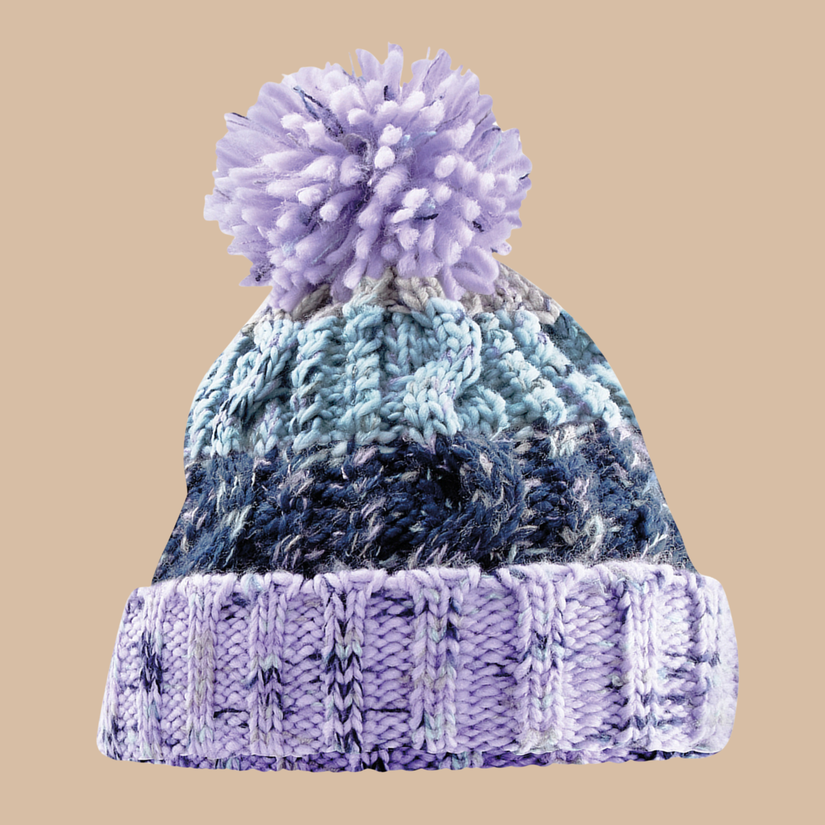 A chunky knit pom-pom beanie hat featuring a gradient colour scheme from light lavender and blue to dark navy, set against a solid beige background. Embroidery services from Pathfinder Printworks, based in South Wales.