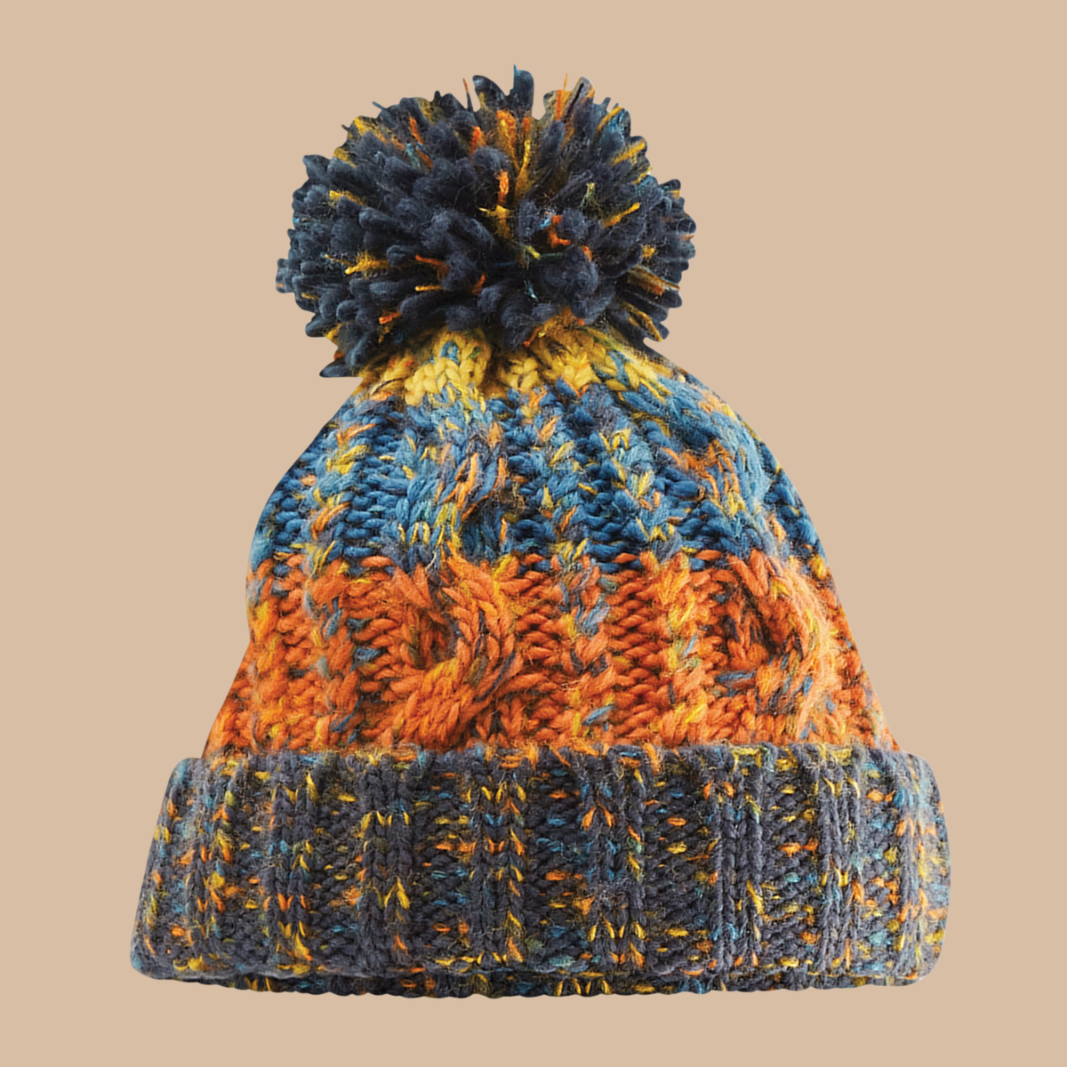 A multicolour cable-knit beanie hat with a large pom-pom on top, featuring stripes of blue, orange, and yellow on a solid beige background. Embroidery services from Pathfinder Printworks, based in South Wales.