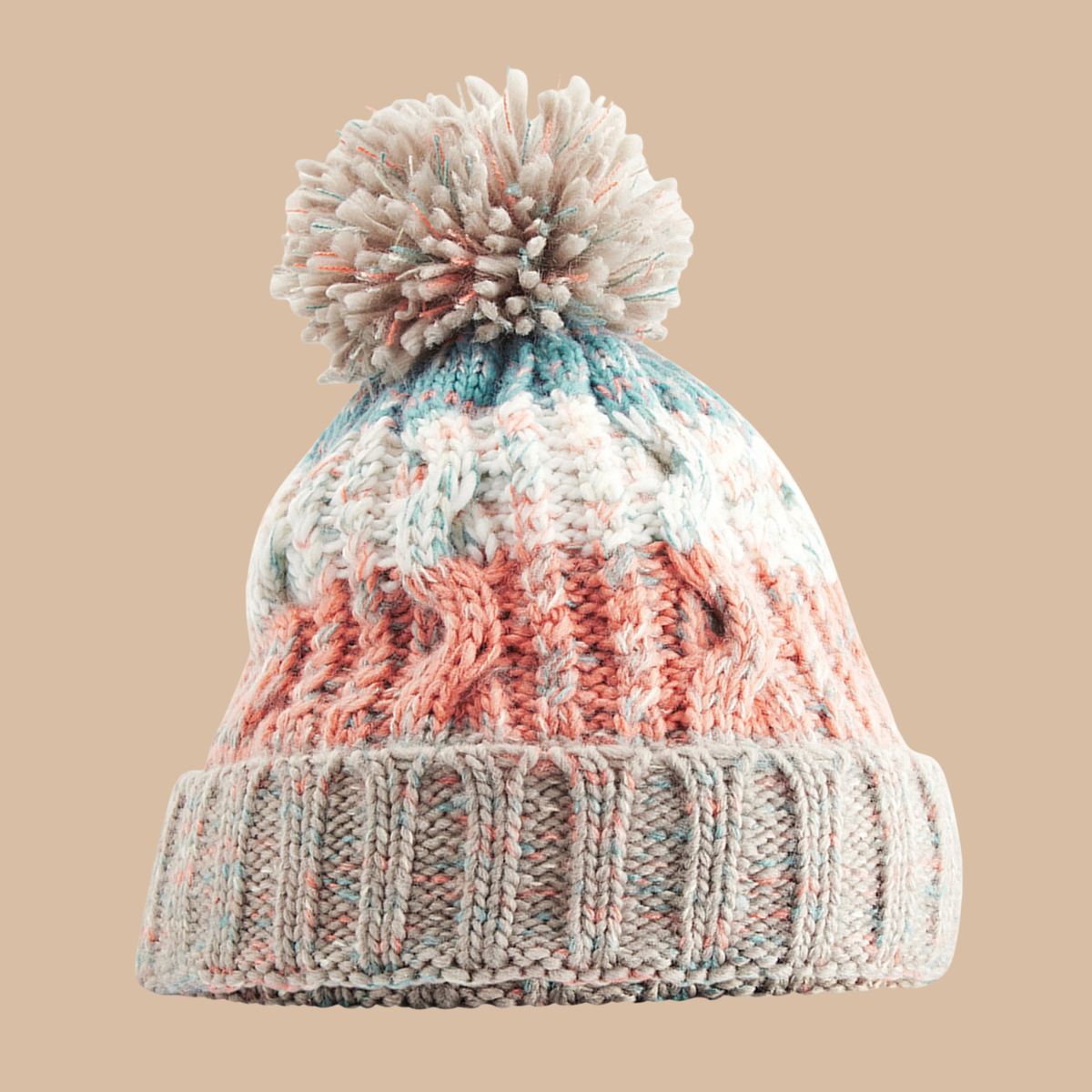 A marled knit pom-pom beanie hat featuring a cable-knit pattern in white, dusty peach, and light blue, with a ribbed cuff, shown against a solid beige background. Embroidery services from Pathfinder Printworks, based in South Wales.