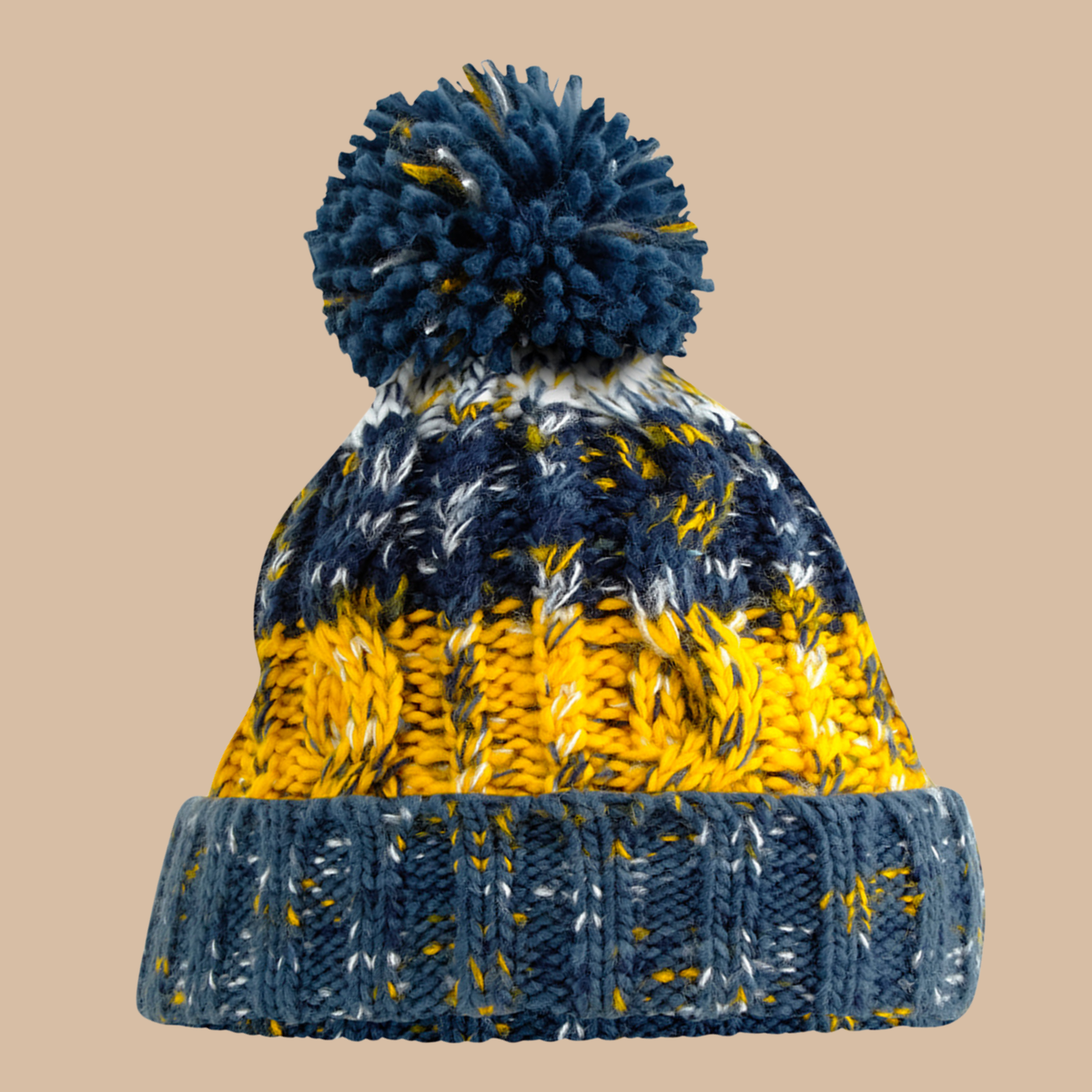 A chunky knit pom-pom beanie hat featuring a navy blue top section, a bright yellow middle band, and a navy blue ribbed cuff with white and yellow flecks, set against a solid beige background. Embroidery services from Pathfinder Printworks, based in South Wales.