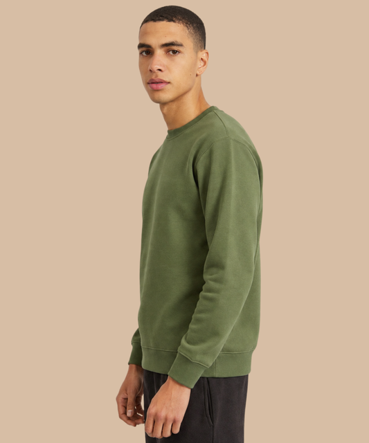 A man wearing an olive green crewneck sweatshirt, shown in a side profile against a solid beige background. Pathfinder Printworks provides printing and embroidery services to teams, clubs and businesses - based in South Wales.