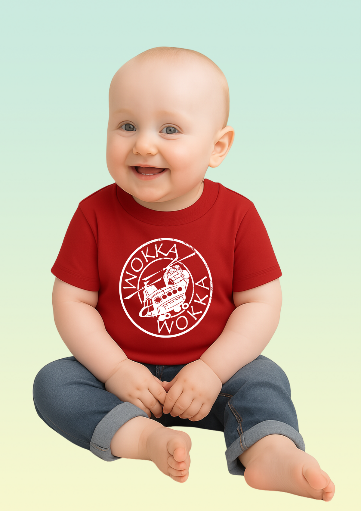 A smiling baby sitting cross-legged, wearing a red short-sleeve t-shirt with a white circular 'WOKKA' graphic and dark grey pants, set against a soft light green to pale yellow gradient background. Exclusive to Flying Teez.