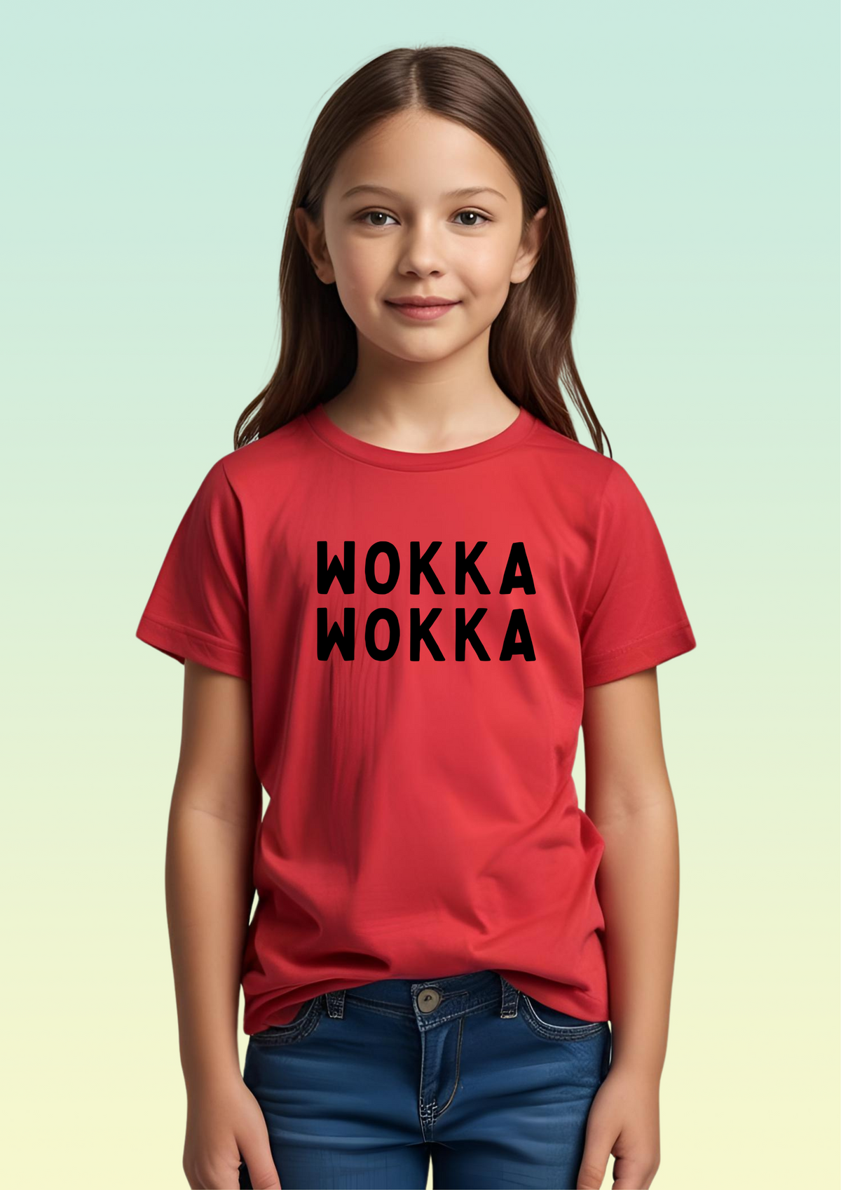 A young girl with long brown hair stands against a light green-to-yellow gradient background, wearing a red short-sleeve t-shirt with 'WOKKA WOKKA' printed in black block letters across the chest, paired with blue jeans. Exclusive to Flying Teez.